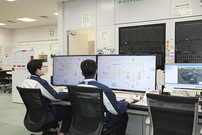 Operators monitoring building systems in a central control room